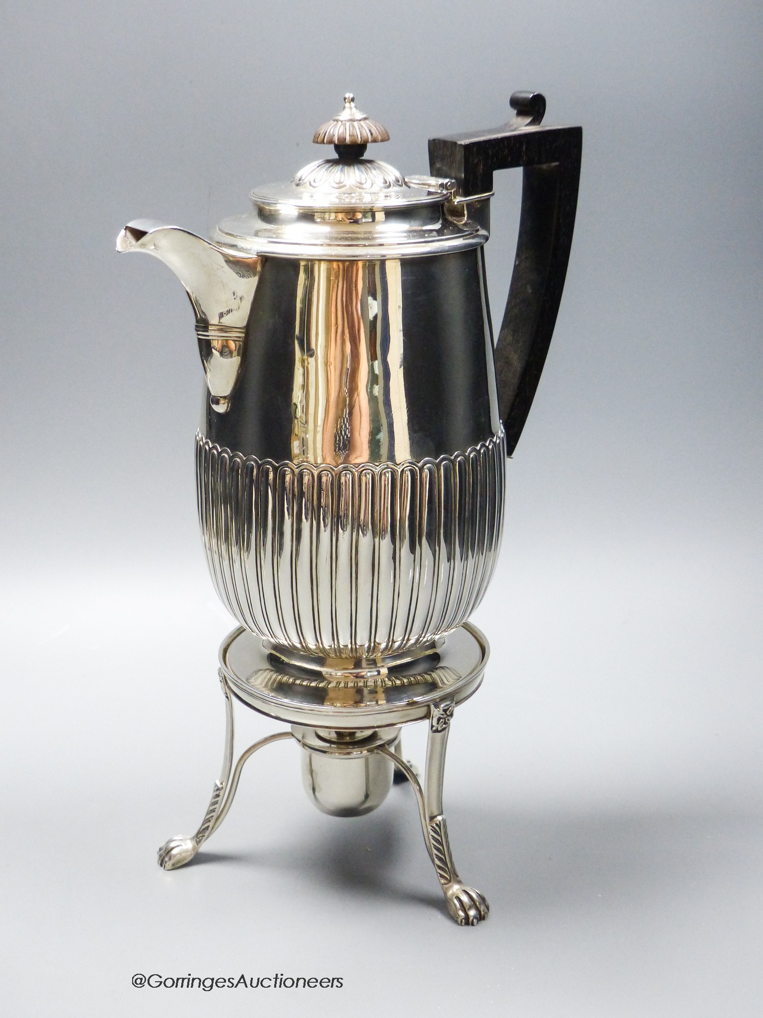 A George III demi fluted silver biggin pot, Burwash & Sibley, London, 1810, on a later matches stand with burner, stand marked for William Bennett, London, 1814, overall 32cm, gross 34.5oz.